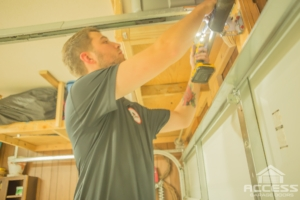 Man installing automatic door