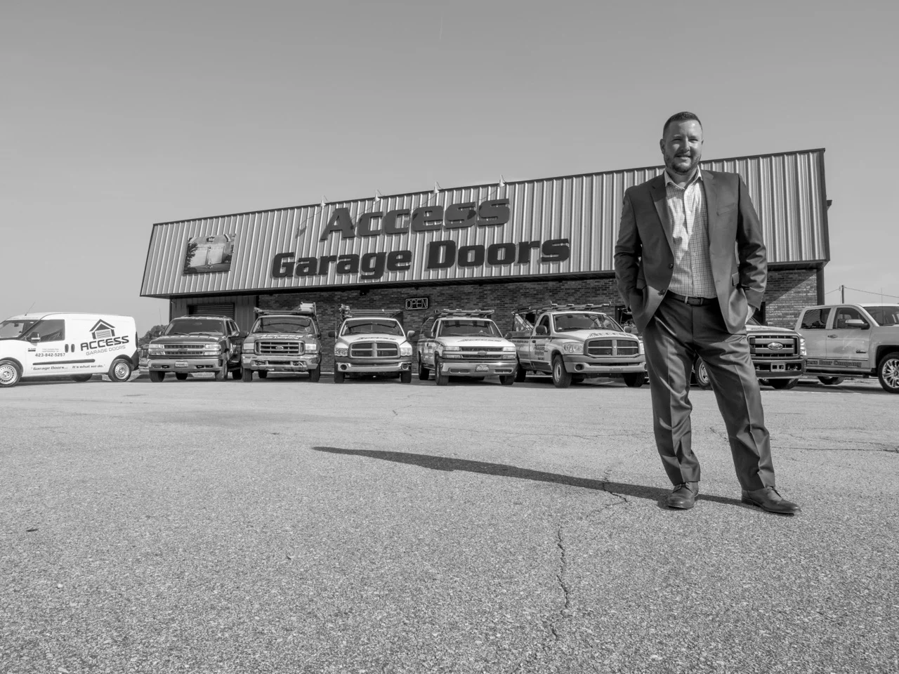 founder in front of access garage doors