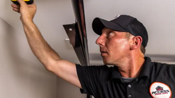 a man working on a garage door